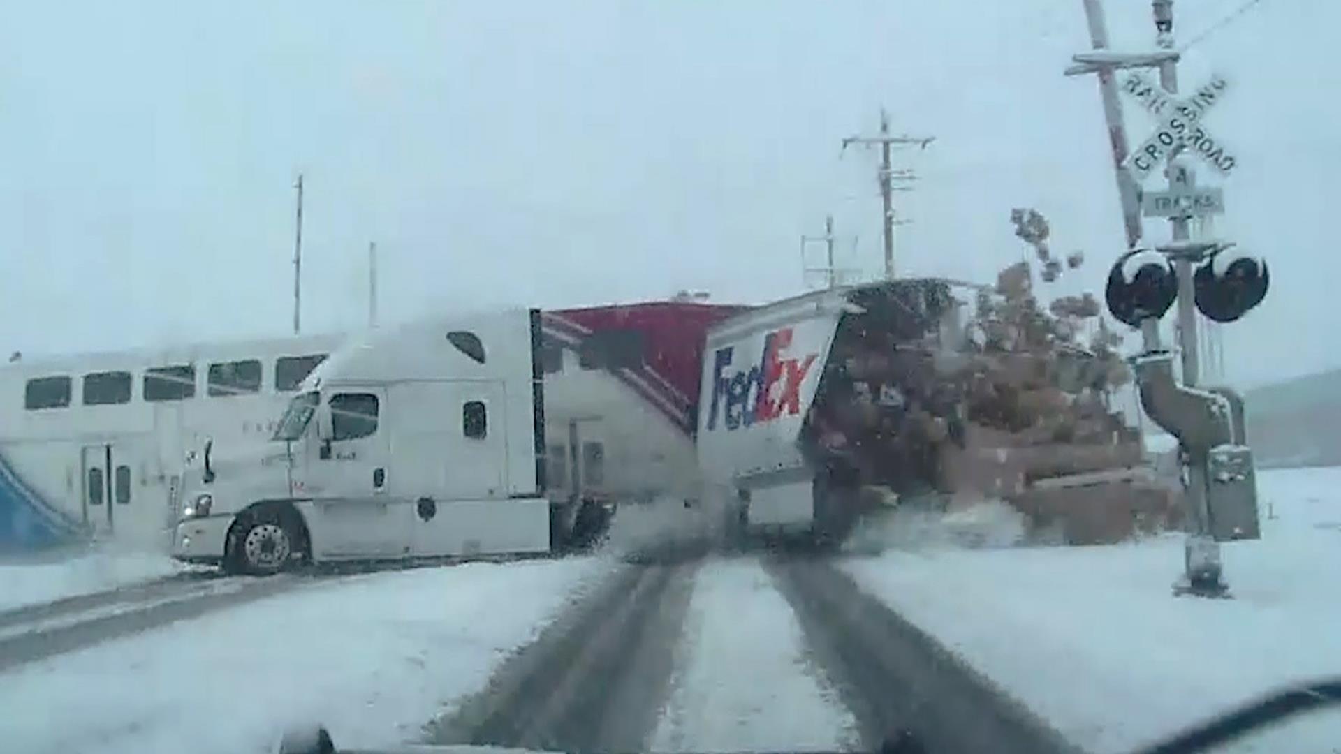 Watch train smash into FedEx truck, miraculously missing the driver