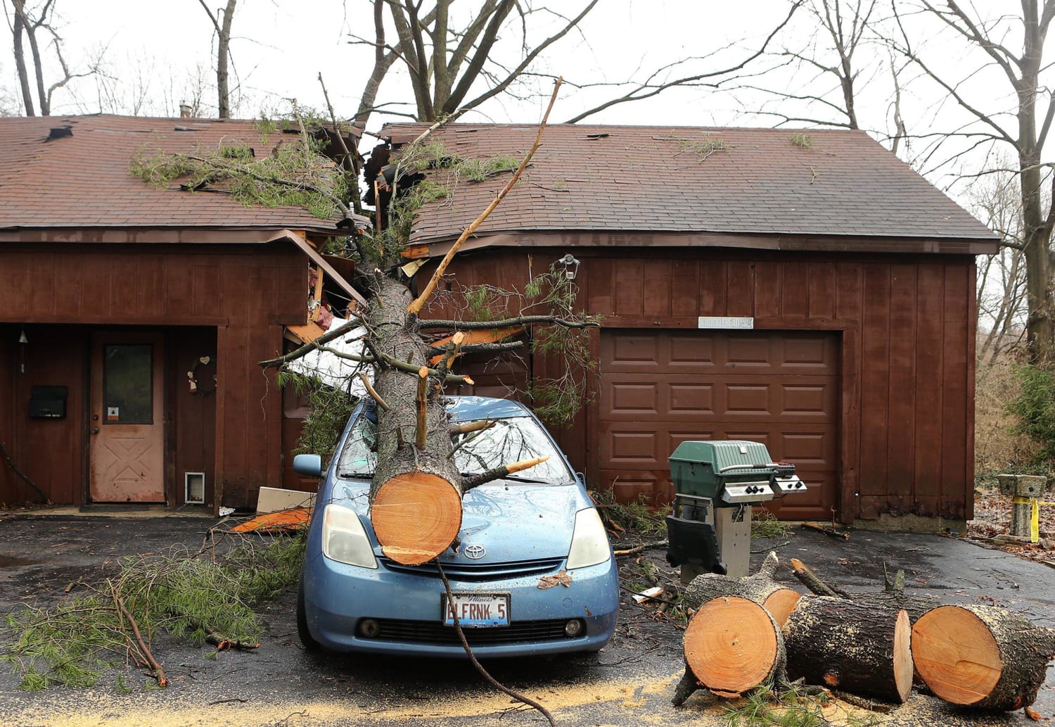 Image: A tree crushed this car and garage in Belleville, Ill.
