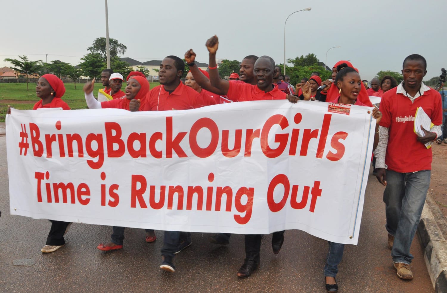 Image: People shout slogans and hold a banner during a demonstration in Abuja, Nigeria