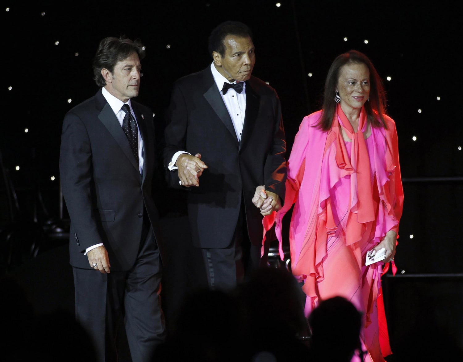Image: Muhammed Ali is escorted on stage by his wife Lonnie Ali and a personal assistant during The Muhammad Ali Celebrity Fight Night Awards XIX in Phoenix