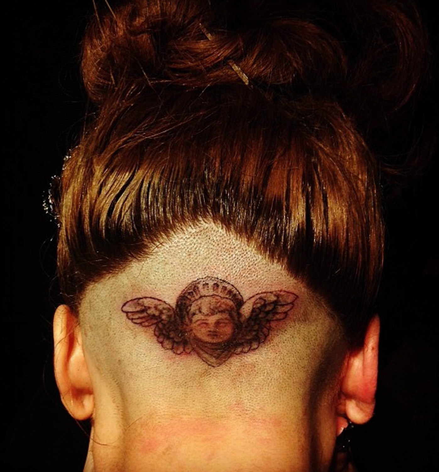 Lady Gaga gets new tattoo on her shaved head at perfume launch