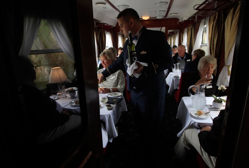 Image: Lunch is served aboard a historic Tehran-bound train as it leaves Budapest