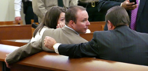 Image: Randall Kerrick and his wife Carrie talk with attorney George Laughrun