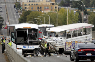 Image: Investigators are pictured at the scene of a crash between a Ride the Ducks vehicle and a charter bus on the Aurora Bridge in Seattle, Washington