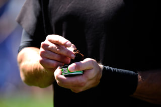 Image: Pat Burrell of the San Francisco Giants uses smokeless tobacco during warm ups