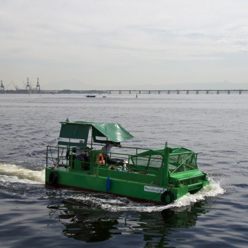 The cleaning vessel "Ecoboat" sails across the polluted waters of Guanabara Bay in Rio de Janeiro, Brazil