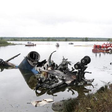 Image: Russian investigators work after 2011 plane crash