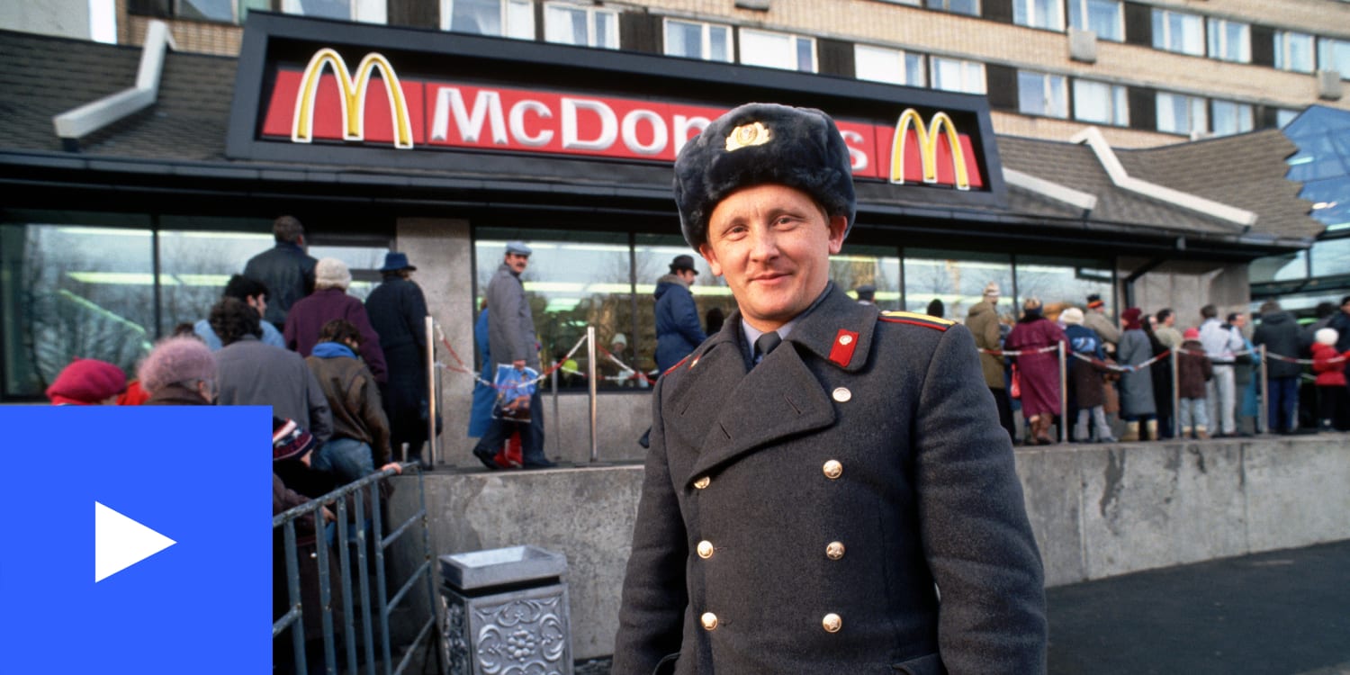 A photo of a Soviet policeman in front of a Moscow McDonald's