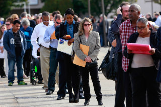 Image: People wait in line to enter the Nassau County Mega Job Fair at Nassau Veterans Memorial Coliseum in Uniondale, New York