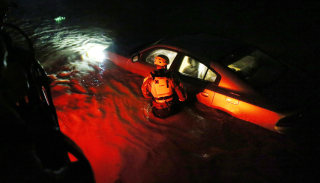 Image: A rescue team inspects flooded areas after Hurricane Irma