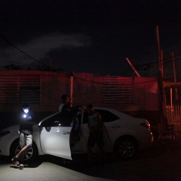 Image: People try to use their mobile phones after Hurricane Maria hit the island and damaged the power grid in Dorado