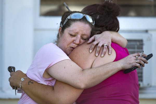 Image: Carrie Matula embraces a woman after a fatal shooting at the First Baptist Church in Sutherland Springs