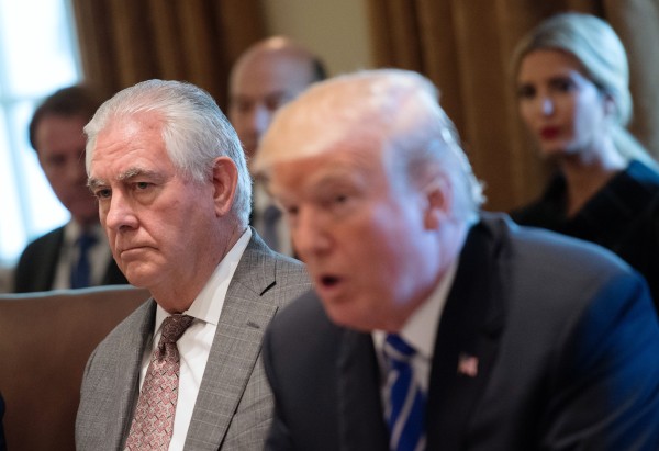 Image: Secretary of State Rex Tillerson listens as President Donald Trump speaks to the media