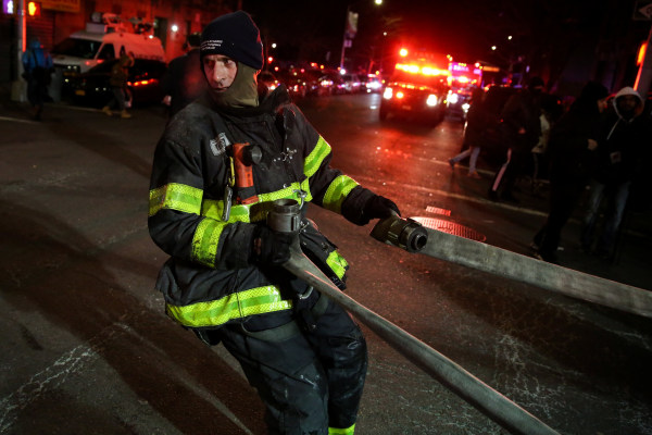 Image: FDNY personnel work on the scene of an apartment fire in New York
