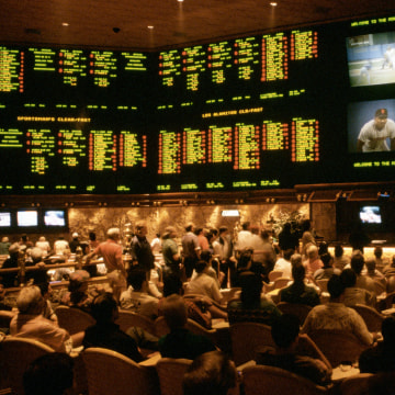 Image: Gamblers bet on a variety of sporting events in the Sports Book, the betting lounge at the Mirage casino.