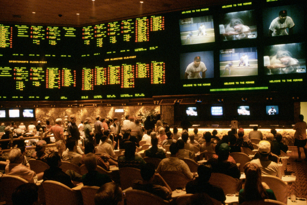 Image: Gamblers bet on a variety of sporting events in the Sports Book, the betting lounge at the Mirage casino.