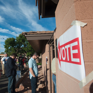 Image: Voters wait in line in front of a polling station in Scottsdale, Arizona
