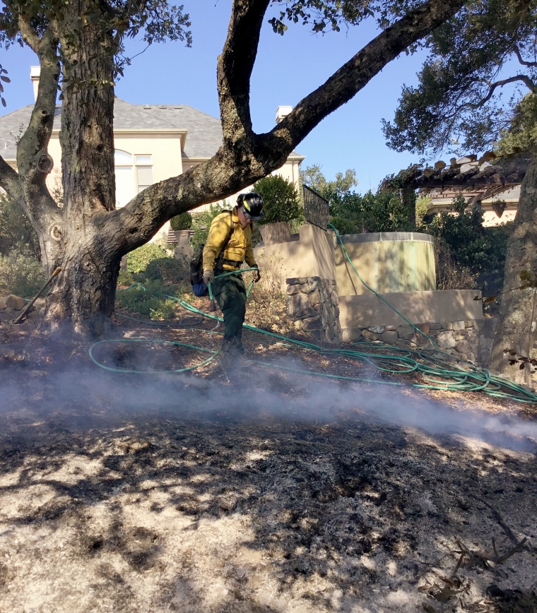 Image: WDS firefighters apply water in their effort to completely extinguish the fire near Giuffrida's home in October 2017.