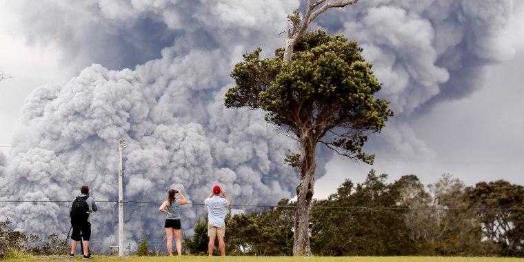 Image: People watch as ash erupt from the Halemaumau crater near the community of Volcano