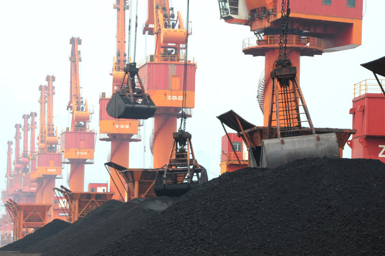Image: FILE PHOTO: Imported coal is seen lifted by cranes from a coal cargo ship at a port in Lianyungang, Jiangsu