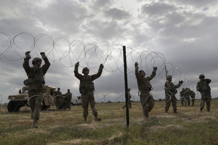 U.S. Army soldiers from Ft. Riley, Kansas string razor wire near the port of entry at the U.S.-Mexico border in Donna, Texas