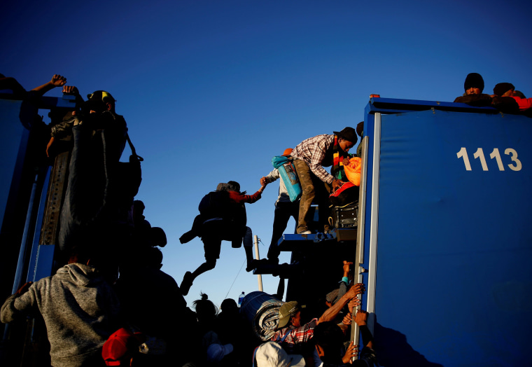 Migrants ride on the back of a truck while making their way to Tijuana from Mexicali, Mexico, on Nov. 20, 2018.