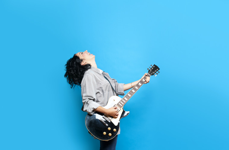 Image: Woman playing guitar
