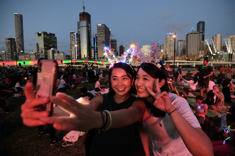 Image: Mizuki and Tsubasa wait to watch the New Year's Eve fireworks at South Bank in Brisbane