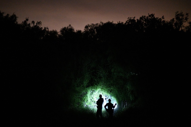 Image: U.S. Border Patrol agents search for undocumented migrants near the Rio Grande near Palmview, Texas.