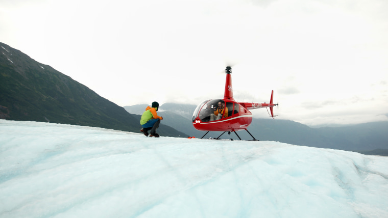 A helicopter lands on the Spencer Glacier in the Chugach National Forest, located in southern Alaska.  The ice has melted so much in the last five years that visitors must land on the ice instead of hiking there.