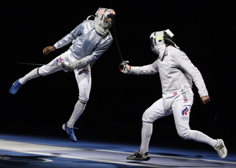 Image: Keeth Smart, left, competes against Stanislav Pozdnyakov of Russia in the semifinals of the men's team saber in fencing