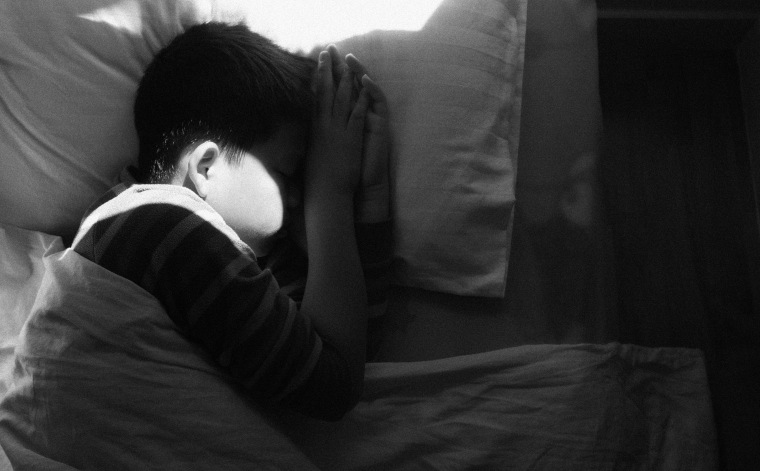 Image: boy asleep in bed