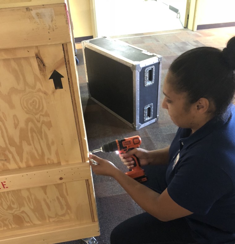 Fazande works to assemble a crate that will carry exhibit displays to different museums across the country.