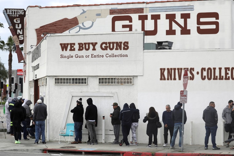 Image: FILE PHOTO: People wait in line outside to buy supplies at the Martin B. Retting, Inc. gun store amid fears of the global growth of coronavirus cases, in Culver City