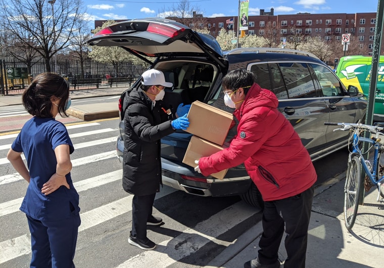 Joey Chiang, president of the Taiwanese Chamber of Commerce of New York, and others help unload boxes of masks they donated to Elmhurst Hospital in Queens.