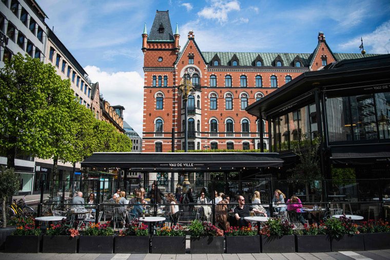 Image: People sit in a restaurant in Stockholm on May 8, 2020, amid the coronavirus COVID-19 pandemic.