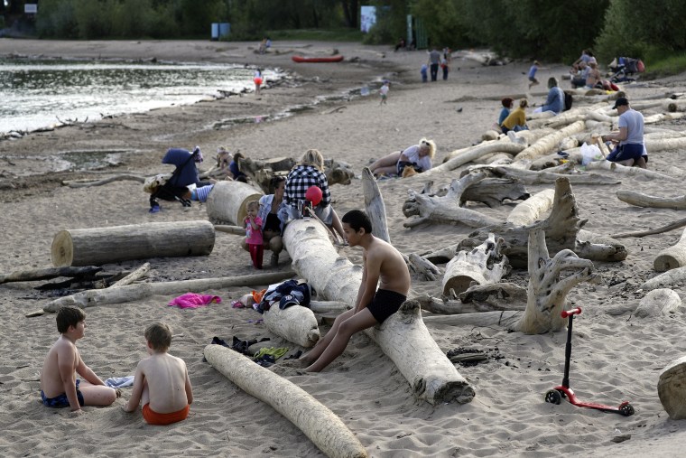 Image: People on a sandy shore of the Novosibirsk Reservoir on the Ob River in Sovetsky District of Novosibirsk, during the pandemic of the novel coronavirus disease