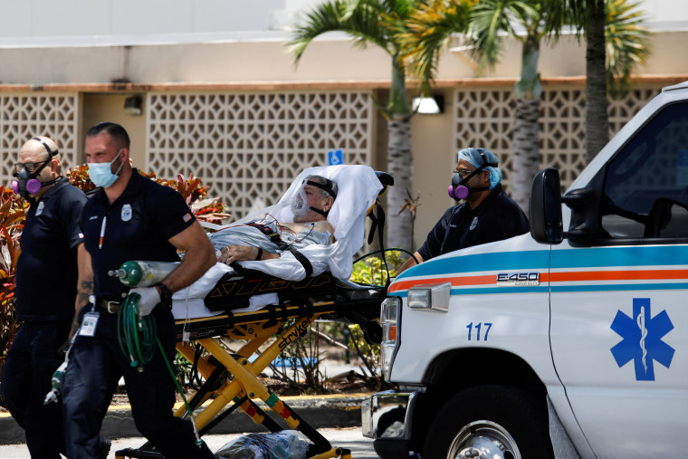 Image: FILE PHOTO: Emergency Medical Technicians (EMT) leave with a patient at Hialeah Hospital where coronavirus disease (COVID-19) patients are treated