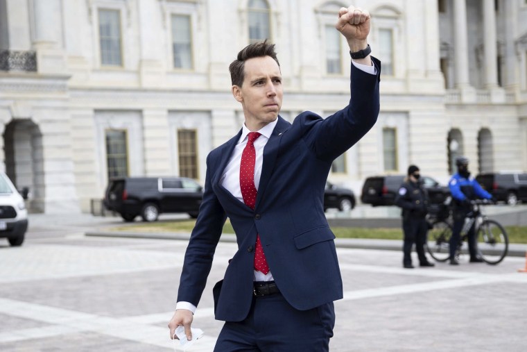 Image: Sen. Josh Hawley, R-Mo. raises his fist toward a crowd of supporters of President Donald Trump gathered outside the Capitol